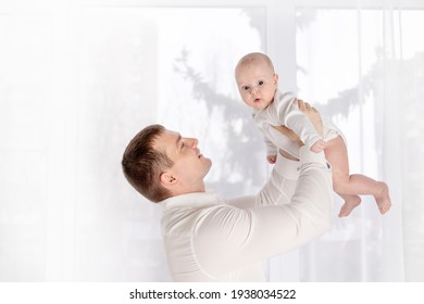 Happy Dad Holding Newborn Baby At Home By The Window, Happy Loving Family Concept, Father's Day