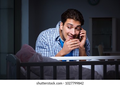 Happy Dad Looking After Newborn Baby At Night