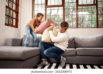 Happy dad, son and couch with pillow fight for bonding, playing or holiday together at home. Father and playful child, kid or little boy with smile for morning, cushion or fluffy game in living room - Powered by Shutterstock