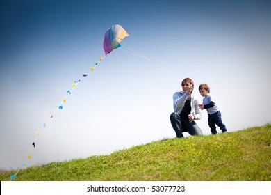 happy dad and son flying a kite together - Powered by Shutterstock