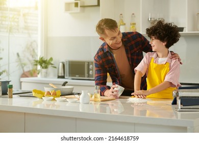 Happy Dad Teaching Preteen Son Making Pasta Dough