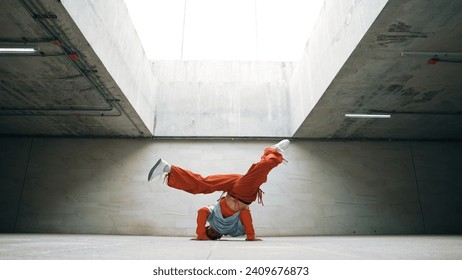 Happy dancing man enjoy practice break dance or freestyle dance in building. Professional b-boy dancer perform energetic movement or doing freeze pose modern life style. Outdoor sport 2024. Sprightly.