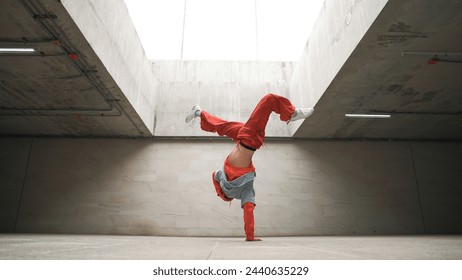 Happy dancing man enjoy practice break dance or freestyle dance in building. Professional b-boy dancer perform energetic movement or doing freeze pose modern life style. Outdoor sport 2024. Sprightly. - Powered by Shutterstock