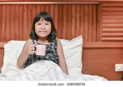 Happy Daughter Drink Milk On Bed Before Sleep, Healthy Concept