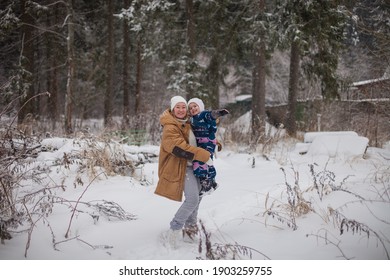 Happy daughter and mother sledging together in winter park