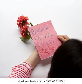 Happy Mother’s day Holiday in Italy. Mom reading handmade greeting card with message in Italian “Buona festa della mamma”. Maternity, Love, Motherhood