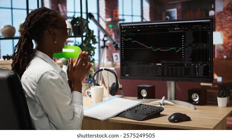 Happy day trader using PC, feeling satisfied after purchasing well performing stocks and selling at a profit. Cheerful forex trader joyous after making money with stock exchange portfolio, camera A