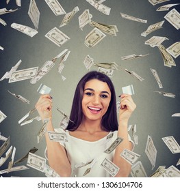 Happy Debt Free Woman Holding A Credit Card Cut In Two Pieces Under Money Rain