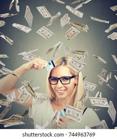 Happy Debt Free Woman Holding A Credit Card Cut In Two Pieces Under Money Rain  