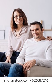 Happy delighted couple sitting at home together - Shutterstock ID 526087246