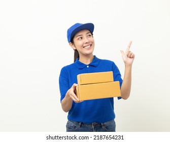 Happy Delivery Asian Woman In Blue Uniform Standing Holding Parcel Cardboard Box On Isolated White Background. Smiling Female Delivery Sending Box Package Service Worker.