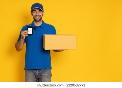 Happy delivery man with a smile arriving with a package for you showing his name tag isolated on yellow background