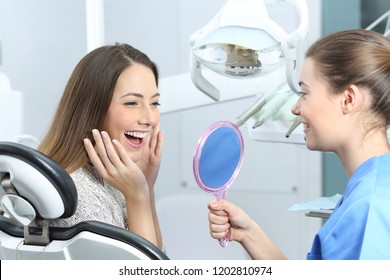 Happy Dentist Patient Checking Whitening Results Looking In A Mirror