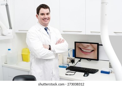 Happy Dentist Posing With Computer Screen