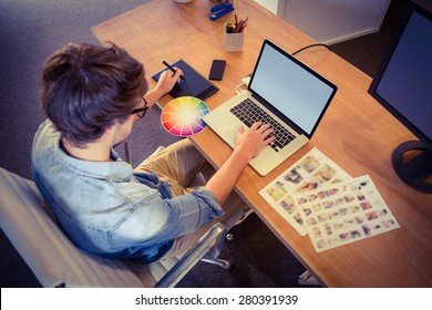 Happy designer working on his laptop in creative office - Powered by Shutterstock