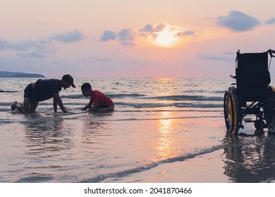 Happy disabled teenage boy and wheelchair playing and relaxing with parent, Activity outdoors with father on the beach background, People having fun and diverse family concept. - Powered by Shutterstock