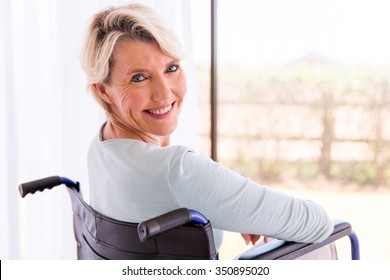 Happy Disabled Woman In Wheelchair Looking Back