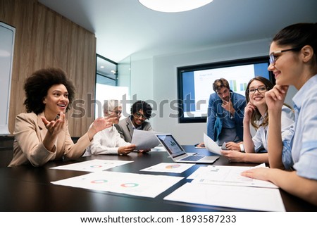 Happy diverse business colleagues meeting, working in modern office