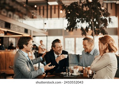 Happy diverse business people laughing in cafe - Powered by Shutterstock