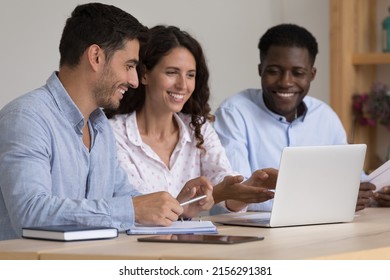 Happy Diverse Business Team Sharing Laptop Computer, Watching Online Project Presentation Together, Making Video Call. Coach Training New Group Of Interns For Job Tasks, Showing Work Software