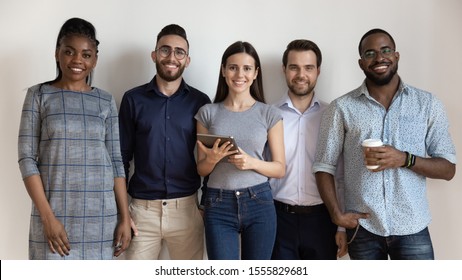 Happy Diverse Businesspeople Or Students Against White Grey Wall Smile Look At Camera, Business Sphere Young Professionals Portrait Of Successful International Staff HR Or University Education Concept