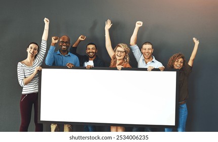 Happy, diverse and cheering marketing team with a blank card, poster or billboard with copyspace in studio on a grey background. A group of smiling business people celebrating and endorsing a product - Powered by Shutterstock