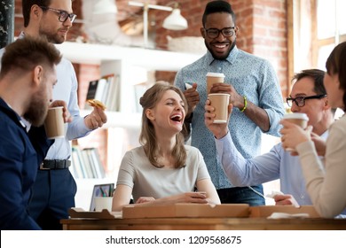 Happy diverse colleagues have fun at lunch break in office, smiling multiracial employees laugh and talk eating pizza and drinking coffee, excited workers celebrate shared win ordering takeaway food - Powered by Shutterstock