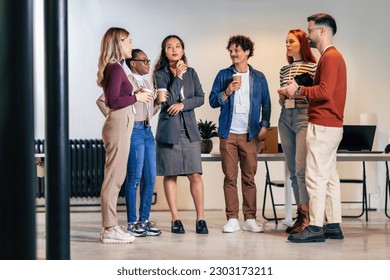 Happy diverse colleagues have fun at lunch break in office, smiling multiracial employees laugh and talk  drinking coffee - Powered by Shutterstock