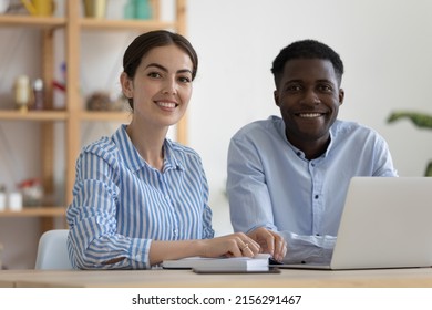 Happy diverse company mentor and African intern at office training center workplace, looking at camera, smiling. Business team coworkers, two employees, student and teacher head shot portrait - Powered by Shutterstock