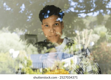 Happy diverse couple embracing and standing by window at home, copy space. Expression, leisure, love, togetherness and domestic life unaltered. - Powered by Shutterstock