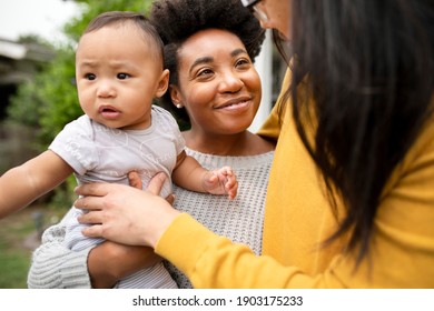 Happy Diverse Family Standing In Front Of The House During Pandemic