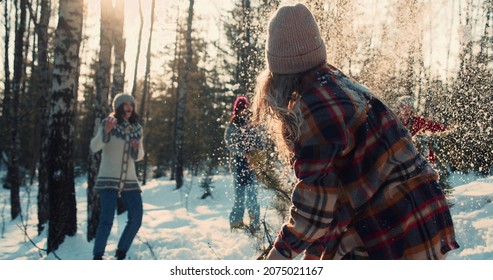 Happy Diverse Friends Enjoy Fun Snowball Fight At Sunny Winter Forest With Dog On New Year Vacation Together Slow Motion