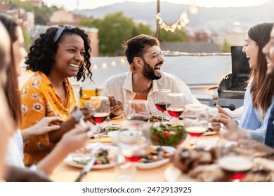 Happy diverse group of friends enjoying dinner barbecue in summer at home terrace. - Powered by Shutterstock