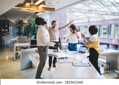Happy diverse male and female colleagues dressed in smart casual clothing celebrating completed project in office workspace, excited partners satisfied with brainstorming meeting for cooperation - Shutterstock ID 1823621360