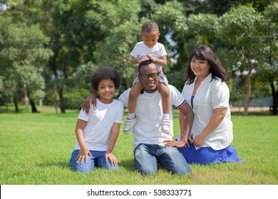 Happy Diverse And Mixed Race Family Group Photo In The Park