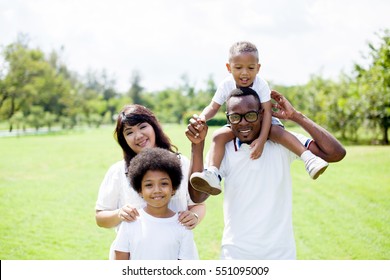 Happy Diverse And Mixed Race Family Group Photo In The Park.