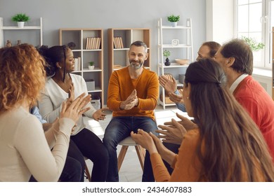 Happy diverse people applauding mature man in group therapy. Team of grateful patients thank therapist for good psychological help session. Success, positive encouragement, overcoming problems concept - Powered by Shutterstock