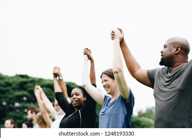 Happy Diverse People Holding Hands In The Park