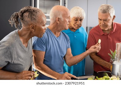 Happy diverse senior friends discussing ingredients for preparing healthy smoothies in kitchen. Senior lifestyle, active retirement, nutrition, health and wellbeing, unaltered. - Powered by Shutterstock