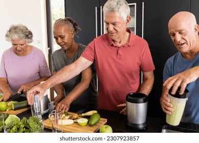 Happy diverse senior friends talking and preparing healthy smoothies together in kitchen. Senior lifestyle, active retirement, nutrition, health and wellbeing, unaltered. - Powered by Shutterstock