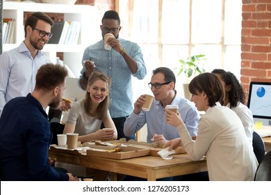 Happy Diverse Team Talking Having Fun Drinking Coffee Eating Pizza Together, Multi-ethnic Employees Group Enjoy Takeaway Food Friendly Conversation Share Lunch Chatting Laughing At Office Work Break