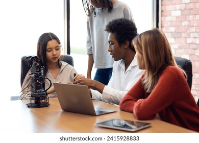 Happy diverse teens students group building robotic  hand using tablet computer. Building And Learning To Program electric Robot. STEM coding engineering class. - Powered by Shutterstock