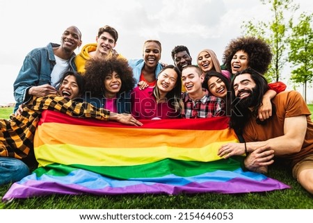 Happy diverse young friends celebrating gay pride festival - LGBTQ community concept 