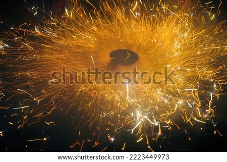 Happy Diwali Celebration with exploding of Firecracker. Ground spinner firework cracker exploding during Indian Festival of Lights. Long exposure shot captured at low light.