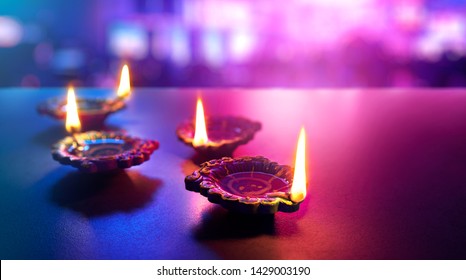 Happy Diwali - Colorful clay diya lamps lit during diwali celebration - Shutterstock ID 1429003190