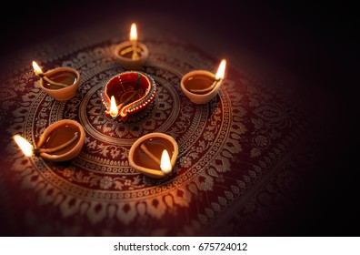 Happy Diwali - Diya lamps lit during diwali celebration - Powered by Shutterstock