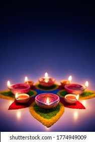 Happy Diwali, Diya oil lamps on colorful rangoli with copy space