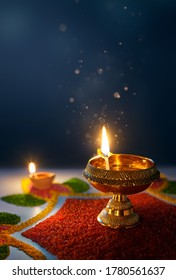 Happy Diwali, Glittering diya oil lamp against dark background with copy space