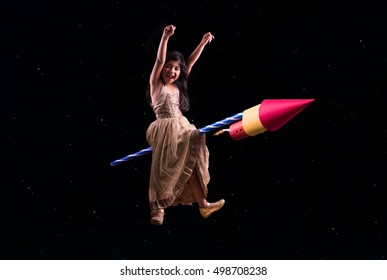 Happy Diwali Greeting Card Showing Cheerful Little Indian Small Girl Sitting On Big Firecracker Or Rocket And Flying In The Sky Filled With Stars