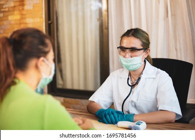 Happy Doctor Female Wearing Face Mask Attending To Her Patient In A Consultation While Prepair Fever Meter,
Concept Virus Protection